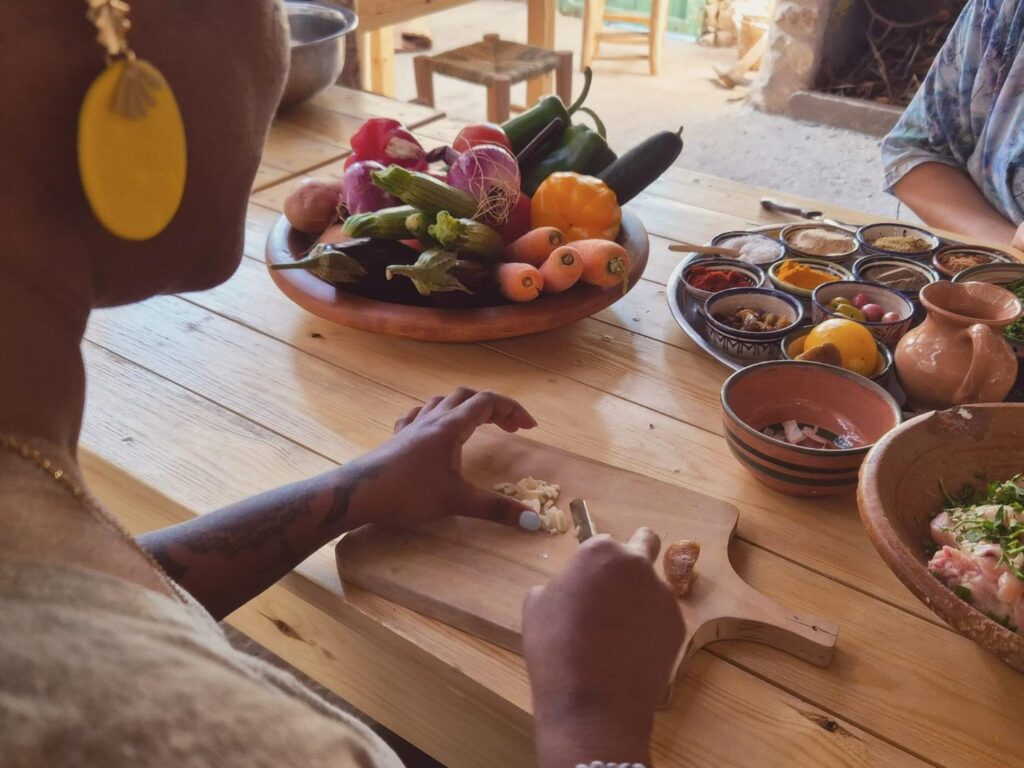 Essaouira cooking class: two women at a table enjoying traditional Moroccan dishes and spices