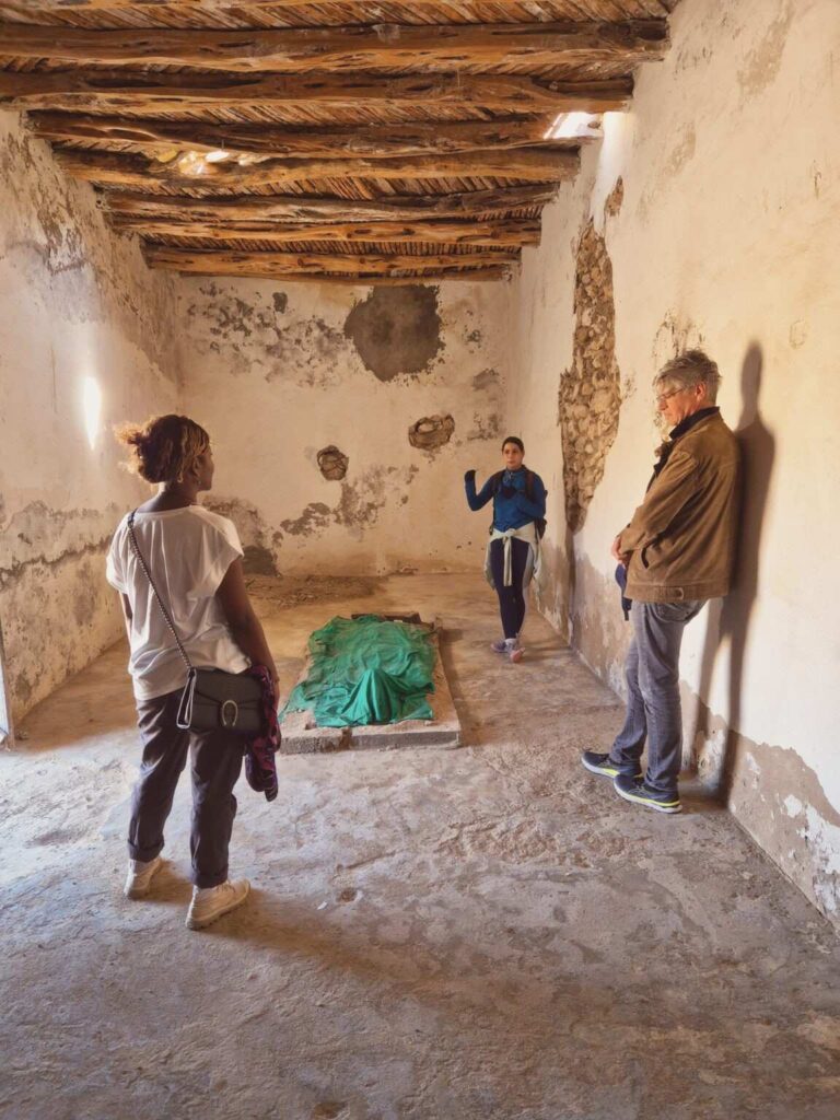 Hike near Essaouira: three people inside an old building at the oasis