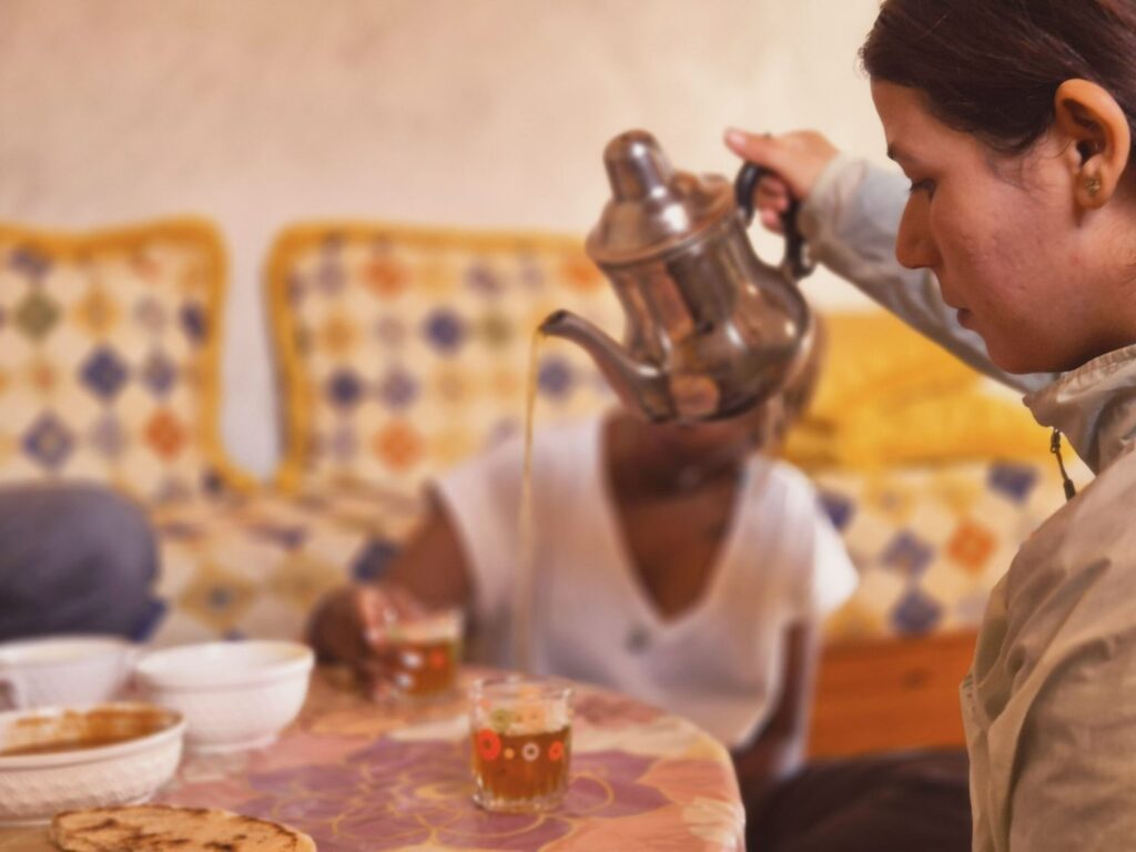 Hike near Essaouira: a woman pouring tea, Moroccan hospitality near the beach